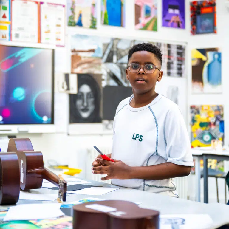 student holding a pair of scissors