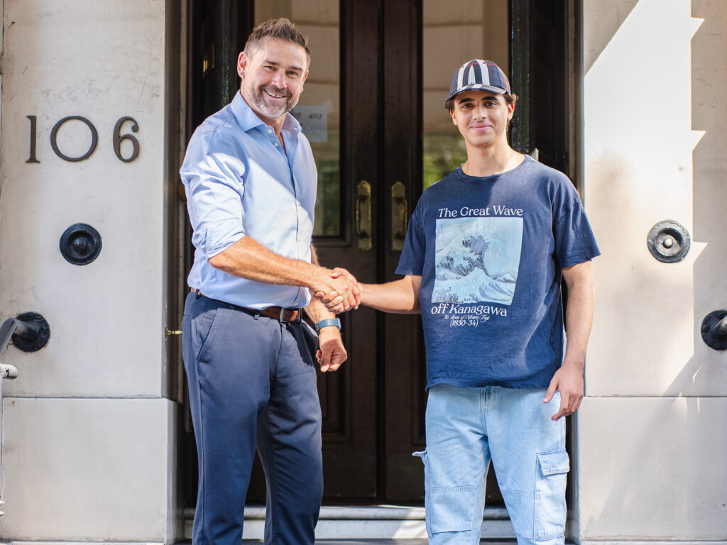 student shaking hand with his teacher